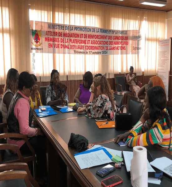 Meeting under the MINPROFF banner 'Atelier de mediation et de renforcement des capacites... Yaounde le 17 octobre 2024'; women seated around a table.